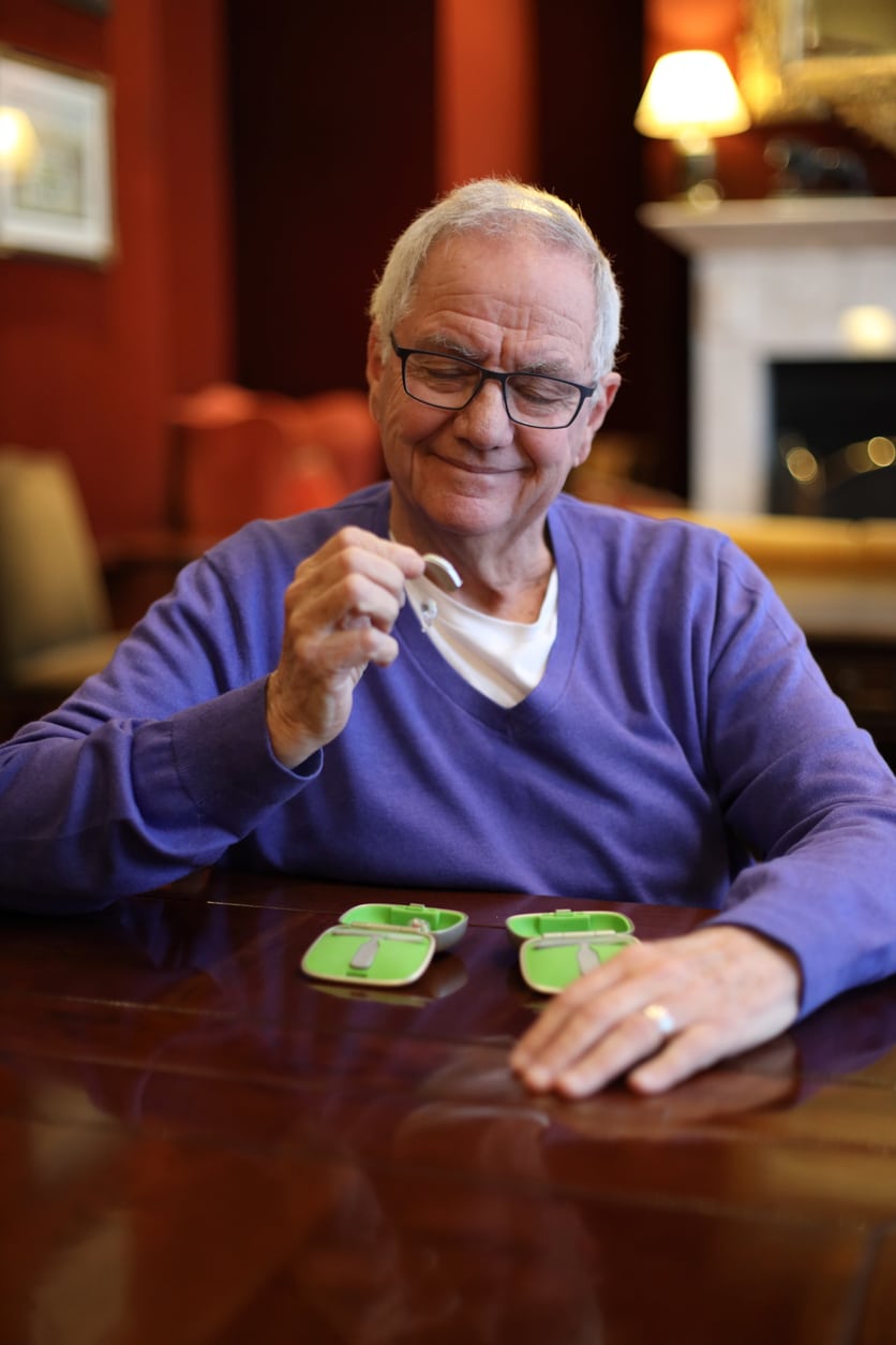 Senior man about to try his new his hearing aid